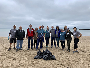 Photo of Sg2/Vizient employees cleaning up Lee Street beach in Evanston, IL